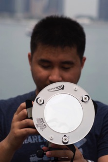 Photographer uses special eclipse filter on lens